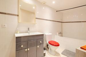 a bathroom with a toilet and a sink and a tub at LA ROUSSETTE in Marseillan +33 photos