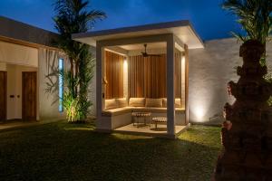 a living room with a couch in a house at Rouge - Loft Emylia in Ubud
