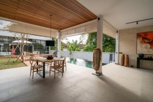 a kitchen and dining room with a table and chairs at Rouge - Loft Emylia in Ubud