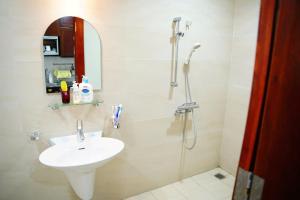 a bathroom with a sink and a shower at The Delice house near Train street, old Quarter in Hanoi +77 photos