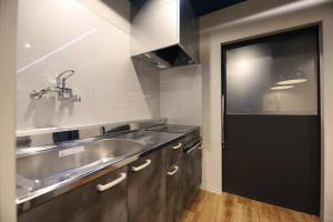a kitchen with a stainless steel sink and a door at Toritonear401-SapporoLocalStory-W-beds2&S-beds2 "無料駐車場付" in Toyohira +140 photos