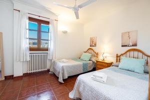 a bedroom with two beds and a window at E415 Can Xisco by Mallorca Villa Selection in Port de Pollensa +34 photos