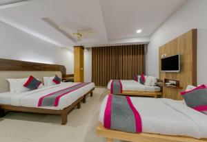 Ένα ή περισσότερα κρεβάτια σε δωμάτιο στο Hotel Vihar Deluxe
