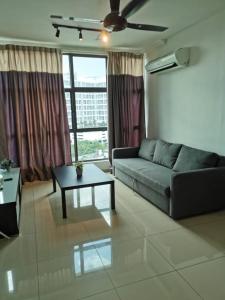 a living room with a couch and a coffee table at Vista Alam P Big Studio in Shah Alam