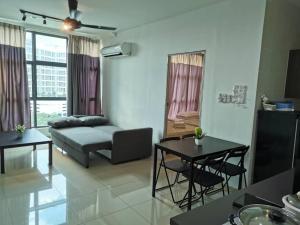 a living room with a couch and a table at Vista Alam P Big Studio in Shah Alam