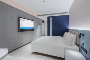 Postel nebo postele na pokoji v ubytování Atour Light Hotel Jinan Olympic Sports Center Provincial Hospital East Hospital