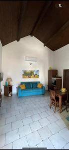 a living room with a blue couch and a table at La Meridiana Antica Residenza in Mesagne