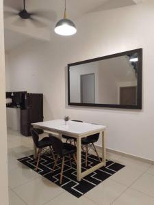a dining room table with chairs and a mirror at UMMA Homestay Jitra in Jitra