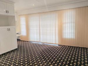 an empty room with curtains and a tile floor at Protea Guest house in Ladysmith +31 photos