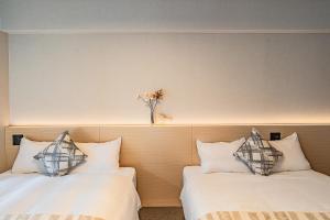 Postel nebo postele na pokoji v ubytování Apartment Hotel 11 Namba Minami 3