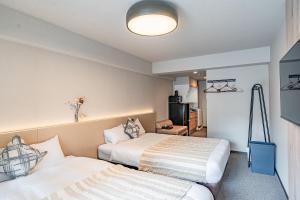 Postel nebo postele na pokoji v ubytování Apartment Hotel 11 Namba Minami 3 + 28 fotografií