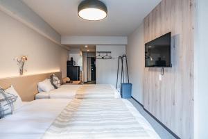 Postel nebo postele na pokoji v ubytování Apartment Hotel 11 Namba Minami 3