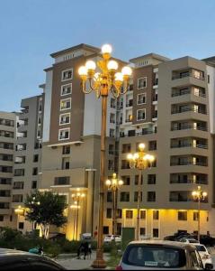 a street light in front of a large building at Serenity Corner in Islamabad