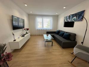 a living room with a couch and a table at Apartmán centrum Spišská Nová Ves in Spišská Nová Ves