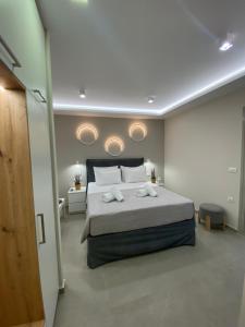 a bedroom with a bed with two towels on it at Armonía Luxury Apartments in Ierápetra