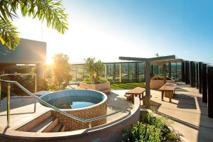 a patio with a hot tub on a building at Resort Living 2BR with Pool Spa Gym & Parking in Brisbane