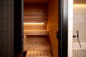 a sauna is shown in a bathroom with wooden walls at Bob W Helsinki Kaarti in Helsinki +39 photos