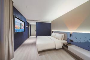 Postel nebo postele na pokoji v ubytování Atour Light Hotel Nanjing Station Hongshan Zoo