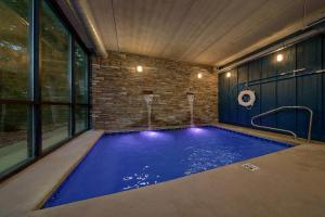 a swimming pool in a room with a brick wall at Cadillac Ranch in Gatlinburg