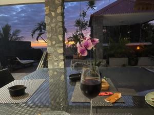a glass of wine sitting on a table with a view at Kaz Mont Vert in Saint-Pierre