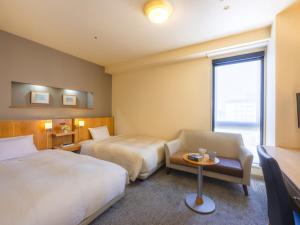 Postel nebo postele na pokoji v ubytování Urawa Washington Hotel