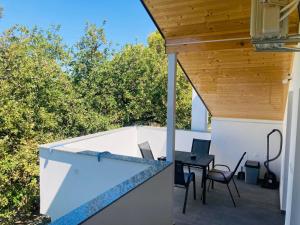 a patio with a table and chairs on a balcony at Apartment Mrkić in Biograd na Moru