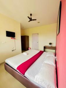 Postel nebo postele na pokoji v ubytování Nilgiris INN