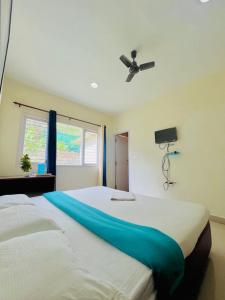 Postel nebo postele na pokoji v ubytování Nilgiris INN