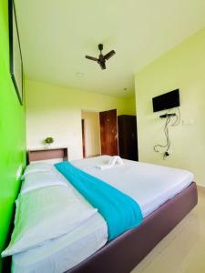 Postel nebo postele na pokoji v ubytování Nilgiris INN