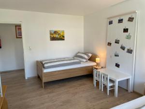 a small bedroom with a bed and a table at Antoniusblick Vacation Apartment in Schlitz