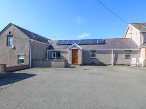 a house with solar panels on the roof at Gwynlys in Holyhead