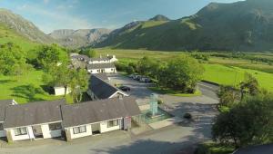 an aerial view of a house with mountains in the background at Snowdonia Mountain Lodge in Bethesda
