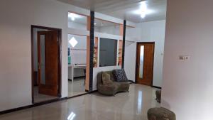 a living room with a chair and a mirror at Bromo Privater villa in Ngadisari