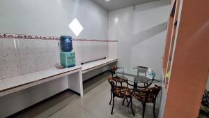 a dining room with a glass table and two chairs at Bromo Privater villa in Ngadisari