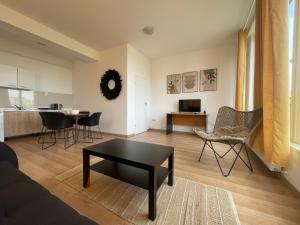 a living room with a table and chairs at NEW Central nr2 Self Checkin OldCity Center Paid Parking with Lift in Timişoara