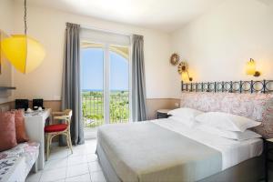A bed or beds in a room at Mangia's Selinunte Resort