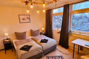 a bedroom with two beds and a window at Celle Apartment for 6 people in Celle