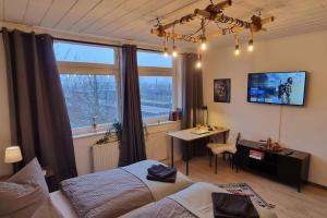 a bedroom with a bed and a desk and a window at Celle Apartment for 6 people in Celle