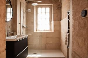 a bathroom with a sink and a shower with a window at Au Formi'Dole, terrasse avec vue canal in Dole +34 photos