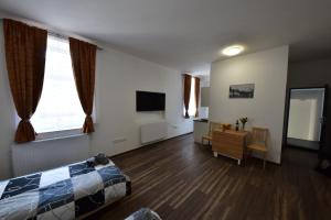 a bedroom with a bed and a desk and window at Ubytování u Ráfy in Žirovnice