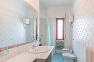 a bathroom with a sink and a toilet and a mirror at Casa Elan Salerno in Salerno +25 photos