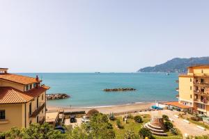 a view of a beach with buildings and the ocean at Casa Elan Salerno in Salerno