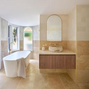 a bathroom with a tub and a sink at Karma Suites - Heart of Montville in Montville