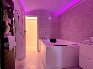 a white bathroom with a purple lighting on the wall at Casa Love in Déville-lès-Rouen