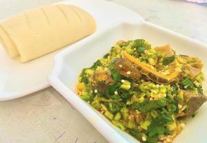 a dish of food with meat and vegetables on a table at Skenyo Hotel & Apartments in Ketti