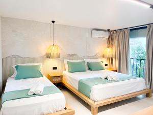 a bedroom with two beds and a window at Siar Rooms in Durrës