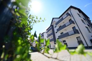 a tall building in the middle of a street at FLH - Apartament Kathy Sibiu in Turnişor