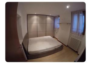 a small bedroom with a bed in a room at Appartamento in Centro Storico - Boutique in Clusone