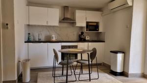 a small kitchen with a table and chairs in it at Apartments No 55 in Baška