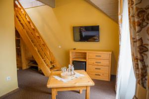 a room with a desk and a tv and stairs at Hotel Monysto in Bukovel
